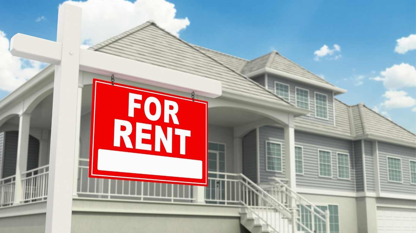house with a red for rent sign in front of it
